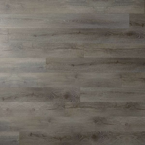 Nadal* features grayish-brown wood grain flooring with a matte finish, highlighting natural knots and subtle color and pattern variations across the planks.