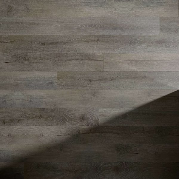 The Nadal* wooden floor features a natural grain texture, with diagonal shadows adding contrast between its lighter and darker sections.