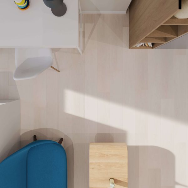 A minimalist room viewed from above shows sunlight streaming over a white desk with a chair, a small wooden table, a blue armchair, and a shelf unit—all resting on Whistler Oak flooring that enhances the space with warmth and natural charm.