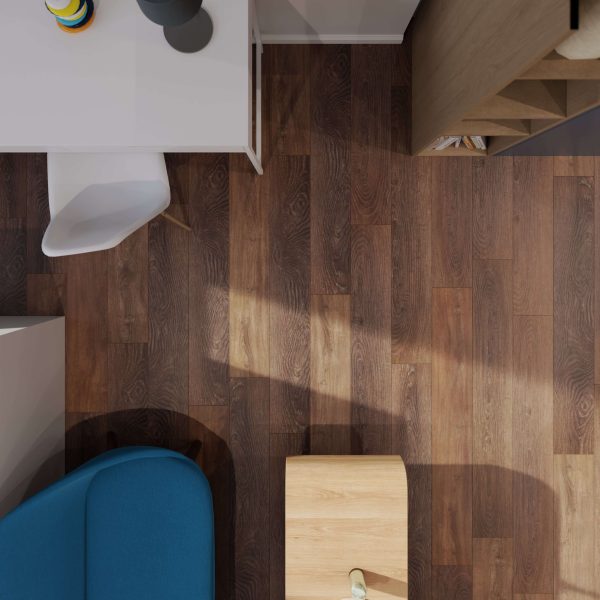 A top-down view of a modern office corner featuring Sydney Oak* flooring, a white desk and chair, a blue sofa, and light wood shelves and table. Soft light casts subtle shadows across the floor.