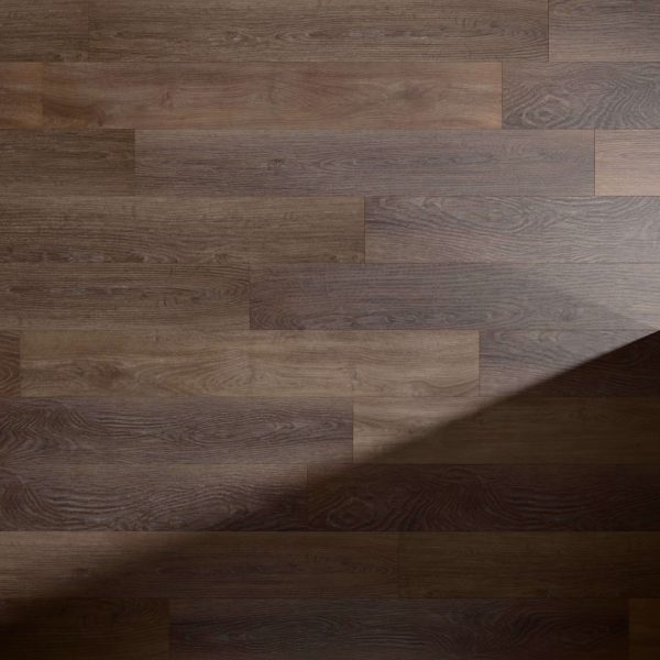 A close-up of Sydney Oak* wooden flooring, featuring dark brown planks in a staggered pattern. A triangular shadow falls diagonally across the lower right corner.