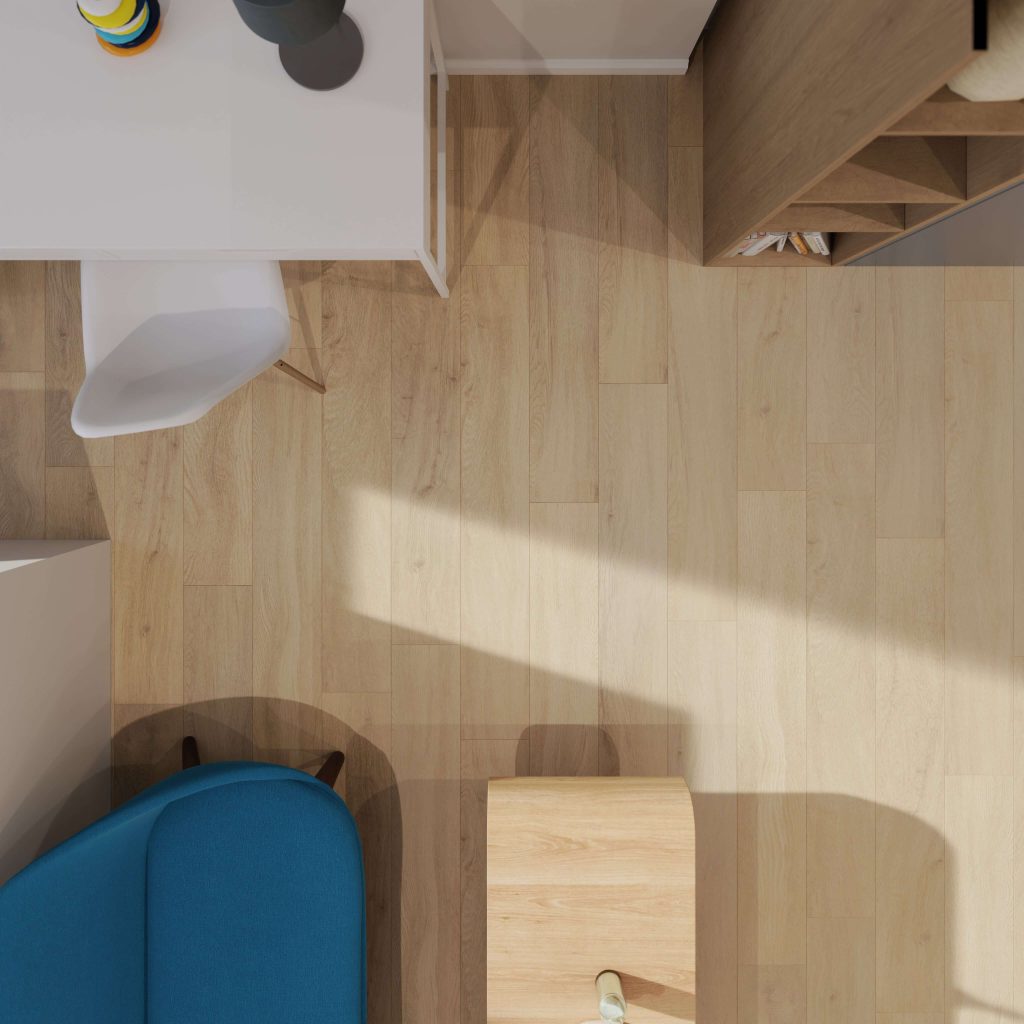 A top-down view of a modern room with Athens Oak flooring, a white desk and chair, a blue sofa, a wooden bookshelf, and a small wooden table. Sunlight casts soft shadows across the floor.