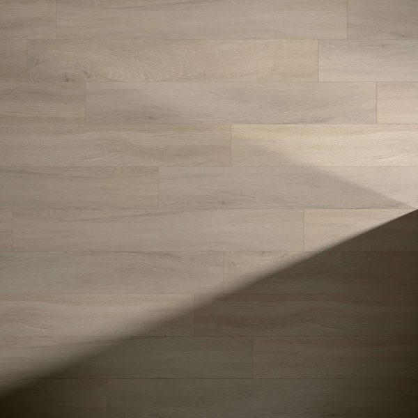 Brodeur light brown wooden floorboards with natural grain feature a diagonal shadow in the lower right, creating striking contrast between illuminated and shaded areas.