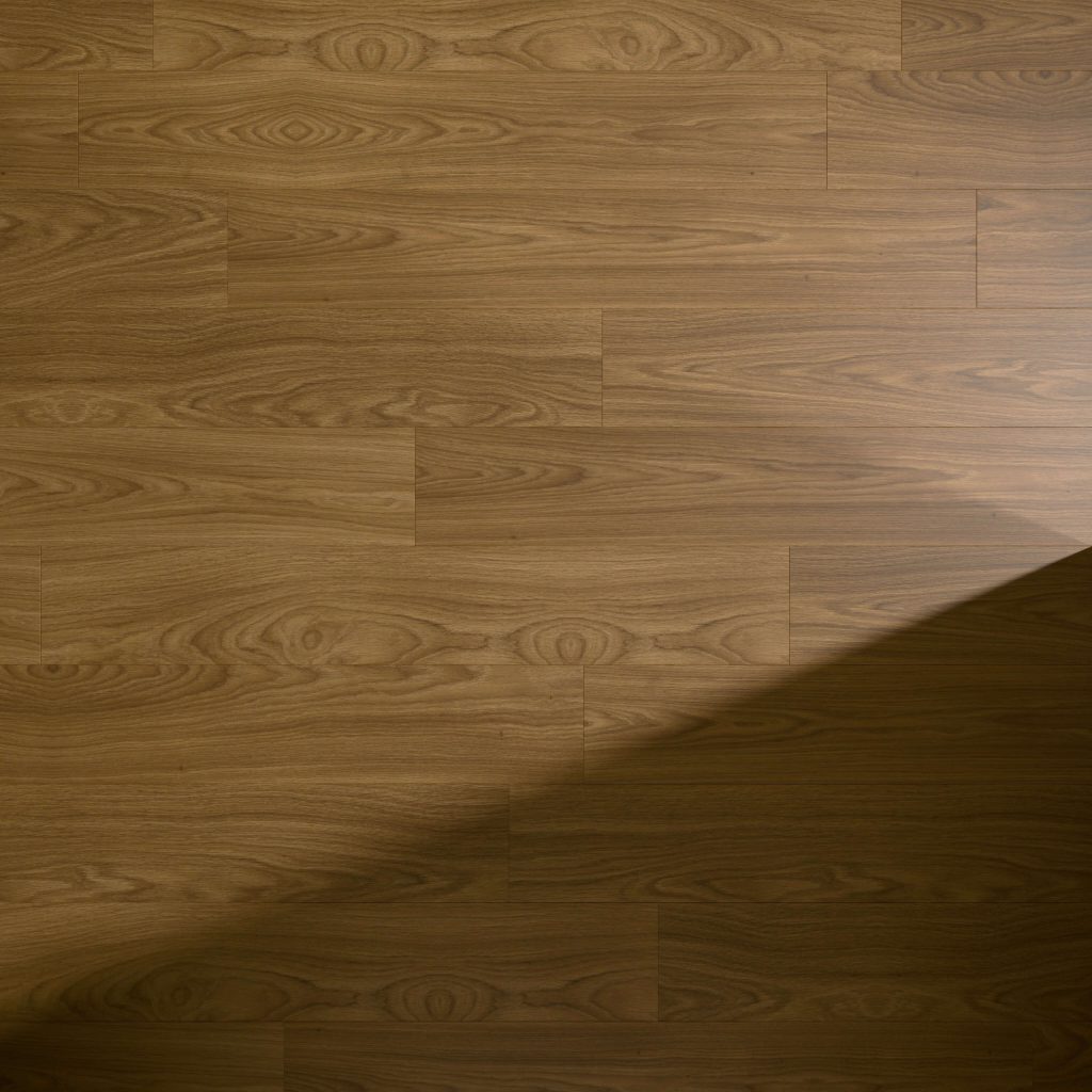 A smooth Brown Toasted Oak floor with a natural grain pattern features wood planks laid horizontally, partially covered by a triangular shadow cast from the lower right corner.