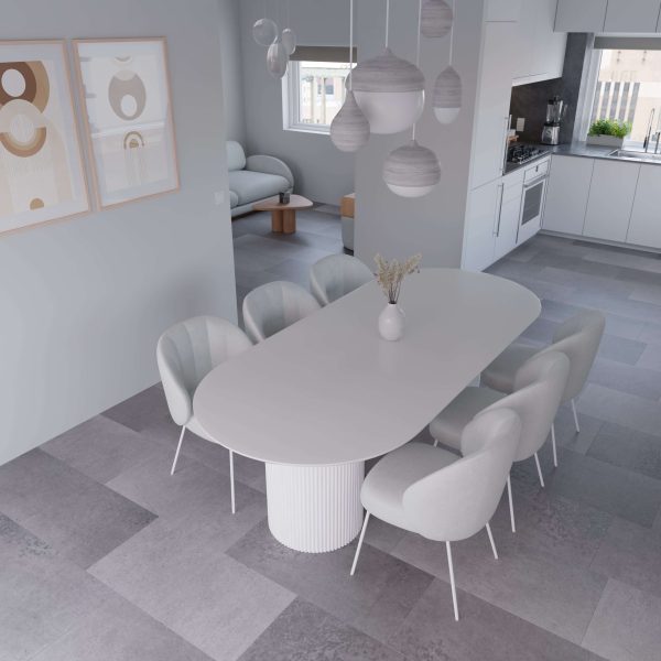 Minimalist dining room with the Industrial* modern oval table, six light grey upholstered chairs, pendant lights above, abstract wall art, grey tiled floors, and an open view to the kitchen and living area.