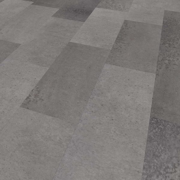 A close-up of a floor featuring Industrial* large rectangular tiles in varying gray shades, arranged in a staggered pattern with a textured, slightly mottled surface.
