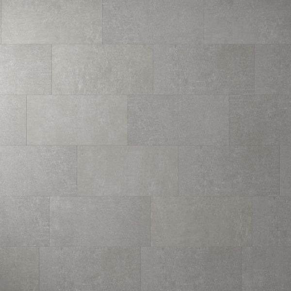 A wall featuring Metro Grey* tiles—large, rectangular, and gray—arranged horizontally in a staggered pattern. The surface has a subtle texture with a uniform, neutral tone.