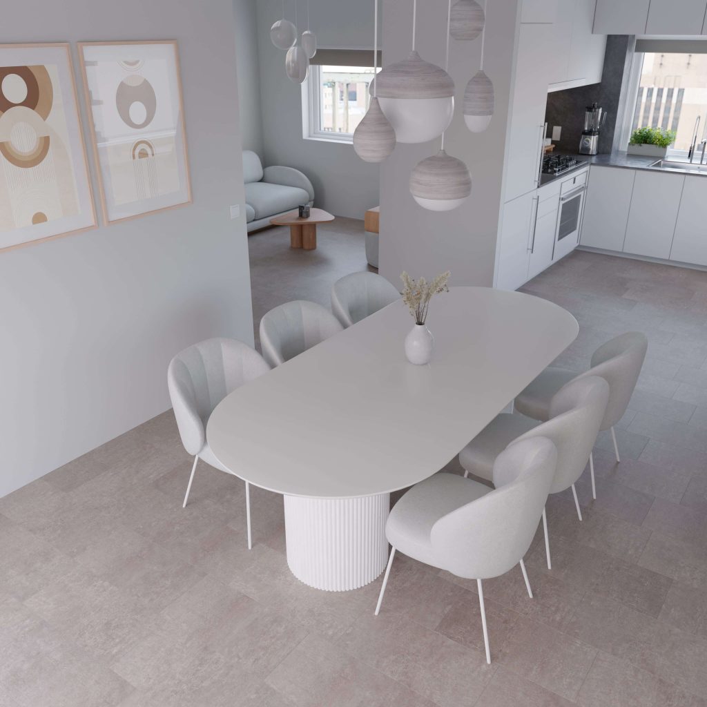 The Amherst* features a modern dining area with an oval white table, eight padded white chairs, pendant lighting, neutral wall art, and views into a minimalist kitchen and living room in soft, muted tones.