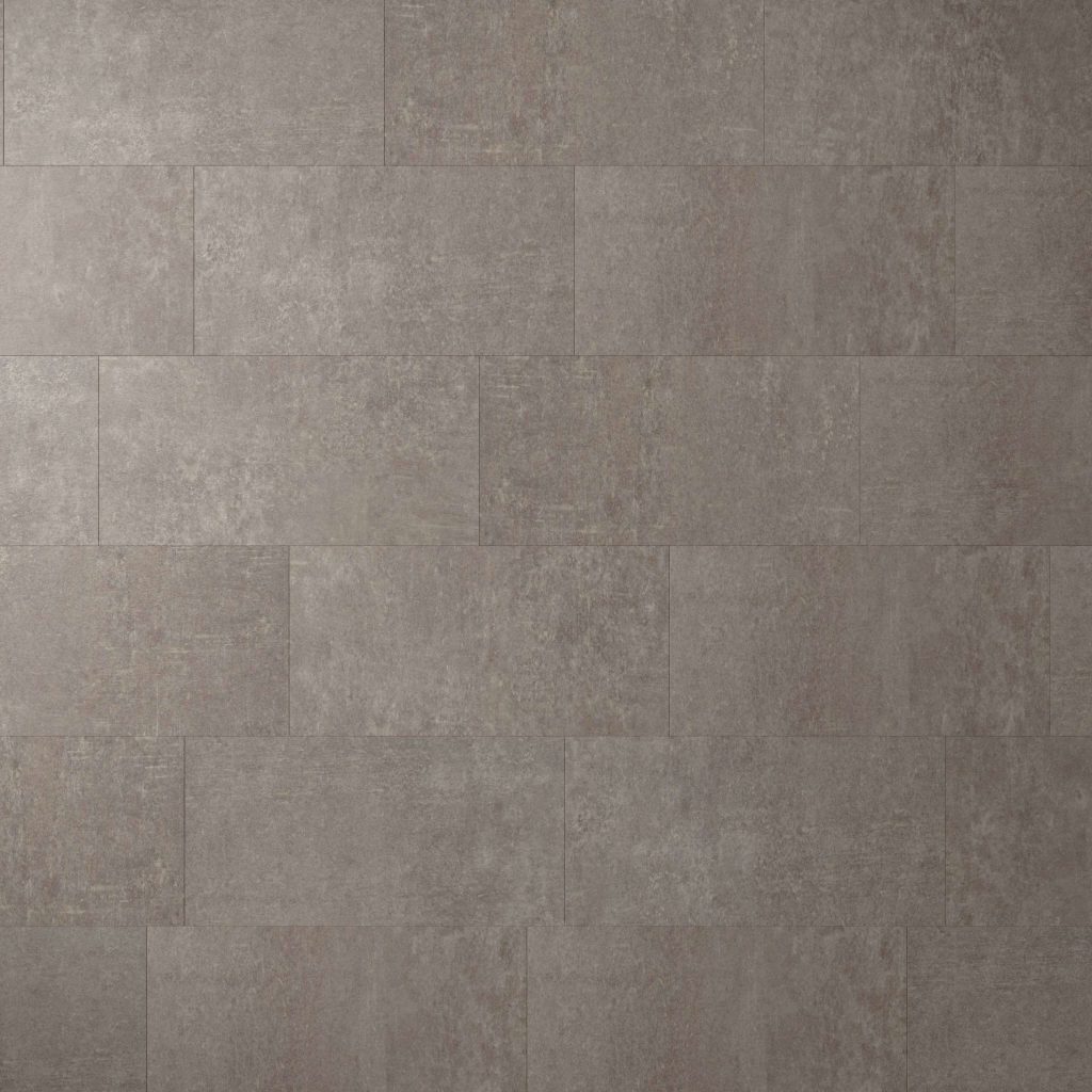 A close-up view of a wall featuring Amherst* tiles in a staggered pattern. These rectangular gray tiles have a subtle, textured, and slightly mottled surface for a modern industrial look.