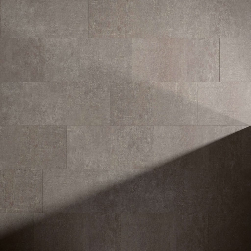Amherst* rectangular brown tiles with a textured surface create a wall, while a diagonal-edged shadow falls across the lower right corner, highlighting the contrast between light and dark.
