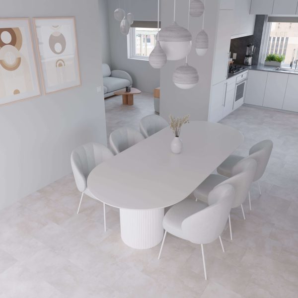 The Modena* dining room features a white oval table, eight matching chairs, minimalist pendant lighting, abstract wall art, and an open kitchen-living area—all in light neutral tones for a modern look.