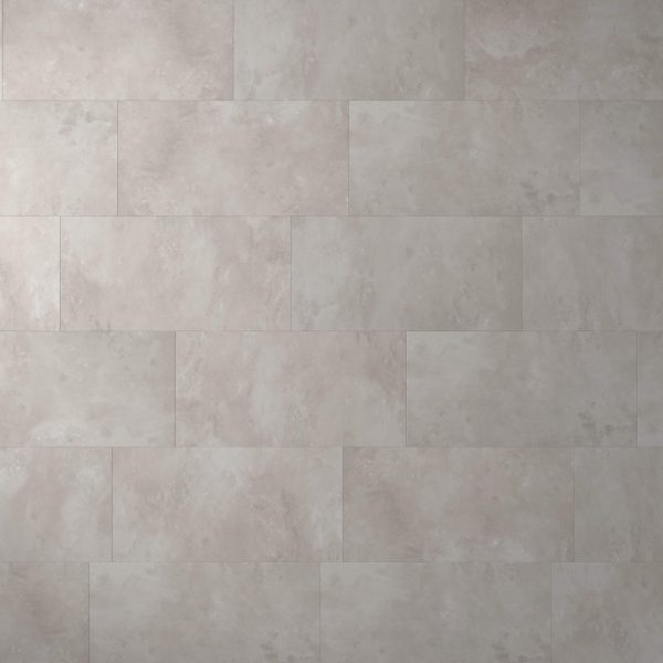 A wall covered with Modena* large, rectangular, light gray tiles in a staggered pattern, featuring a smooth, slightly mottled surface.