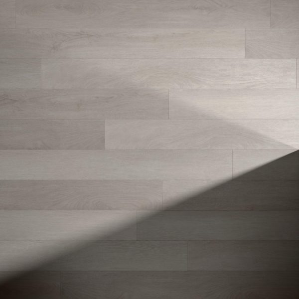 Hendrie features light wooden floorboards with visible wood grain and a smooth surface. A diagonal shadow runs from the lower left to upper right, creating a striking contrast between illuminated and shaded areas.