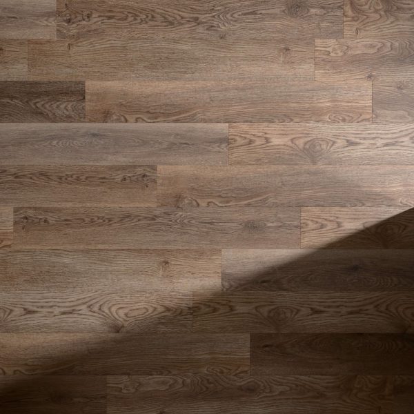 Meadowland features medium brown wooden planks with natural grain and knots, arranged in a staggered pattern. A diagonal shadow appears in the bottom right corner of the image.