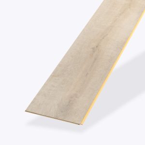 A single Badosa* vinyl flooring plank in light wood color with a subtle grain pattern is displayed on a plain background. The angled plank highlights its thin edges and one yellow groove along the side.