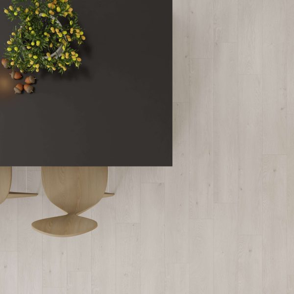 Minimalist top view of a black table with a green and yellow floral arrangement, two wooden chairs, and a Valleggia Oak floor. Most of the image features open space showcasing the elegance of the Valleggia Oak flooring.