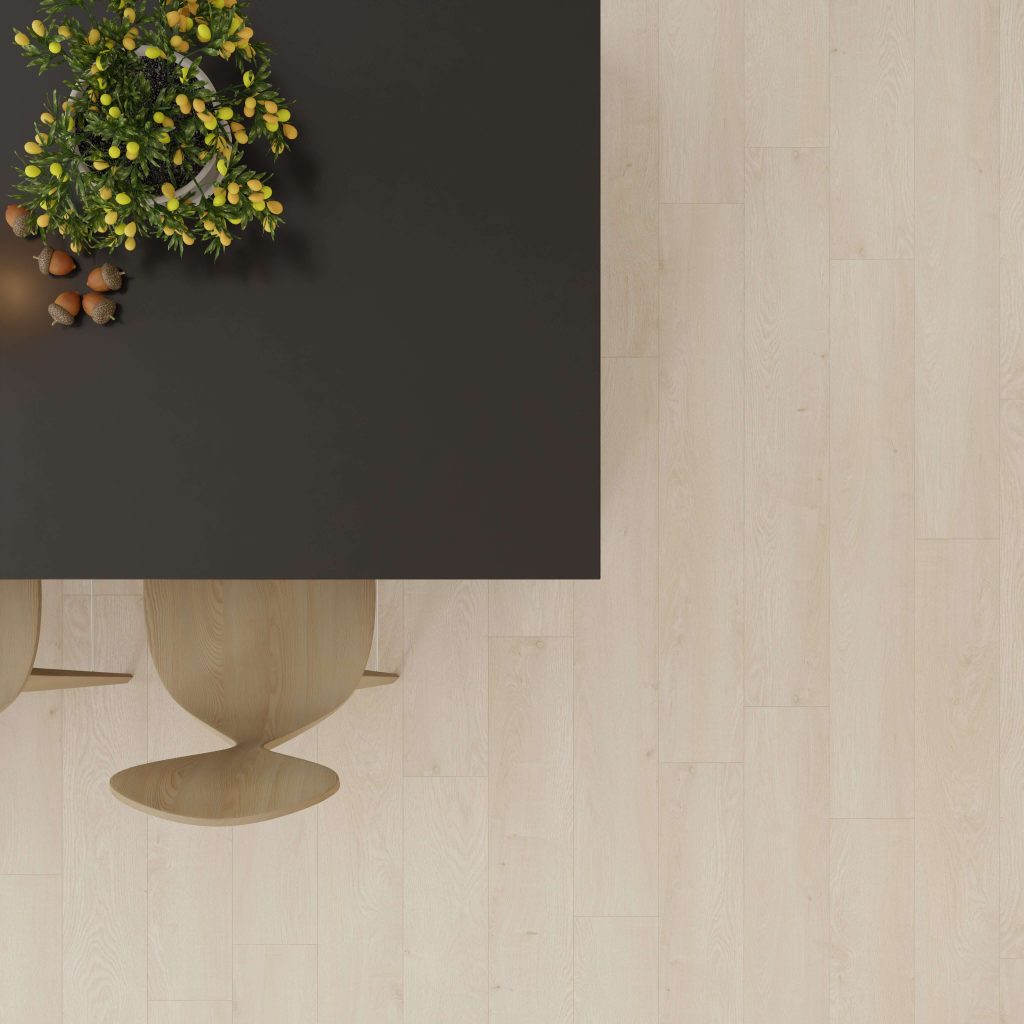 Top-down view of a dark rectangular table with a green and yellow floral arrangement and nuts, beside two light wooden chairs on a Cassis Oak floor. Most of the Cassis Oak flooring is visible empty space.