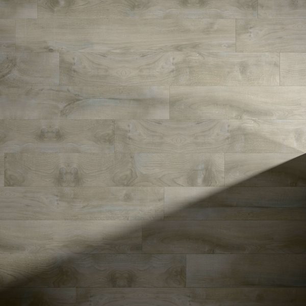 Monaco Oak features a light wood tone with a subtle natural grain, partially shaded by a diagonal shadow in the lower right corner.