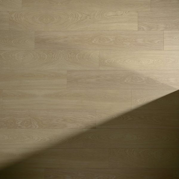 Sausalito Oak flooring features a visible natural grain pattern in light wood, with a diagonal shadow across the bottom right corner, creating a striking contrast between illuminated and shaded areas.