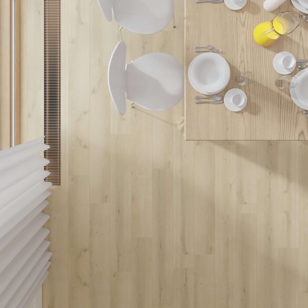 A top-down view of a South Beach Oak dining table set with white plates, cups, cutlery, and a jug of orange juice. Two white chairs are partly visible on the light oak floor near a window.