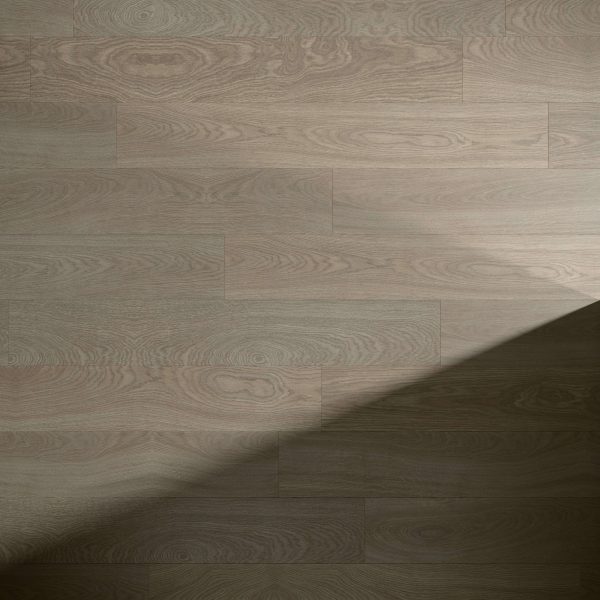 Langley Oak features light brown planks with visible grain patterns. A diagonal shadow crosses from the lower right to the center, highlighting the contrast between illuminated and shaded areas.