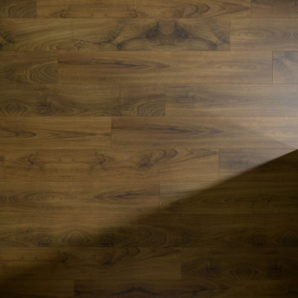 Charlotte Oak flooring features a medium brown finish with natural grain patterns and knots. A diagonal shadow crosses the lower right corner, highlighting the warm tones of these elegant planks.
