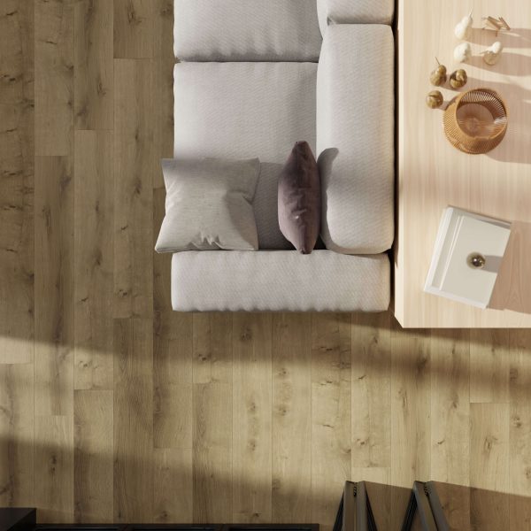 Top view: light gray sofa with two cushions beside a coffee table with decor, all set on Austin Oak* flooring. Sunlight casts shadows across the scene.