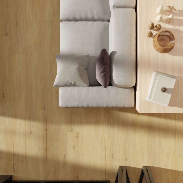 A top-down view of a light gray sofa with two pillows next to a coffee table holding decor, all set on Asheville Oak flooring in a bright, modern living room.