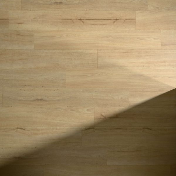 Asheville Oak flooring in light brown shows off visible grain patterns and knots, with a diagonal shadow partially covering the lower right corner.
