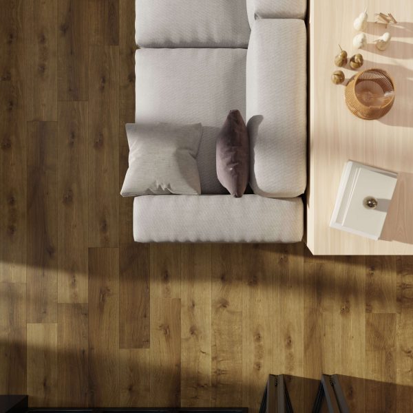 A top-down view of a light gray sofa with two pillows beside a light wood coffee table on Stowe Oak* flooring, styled with decorative items.