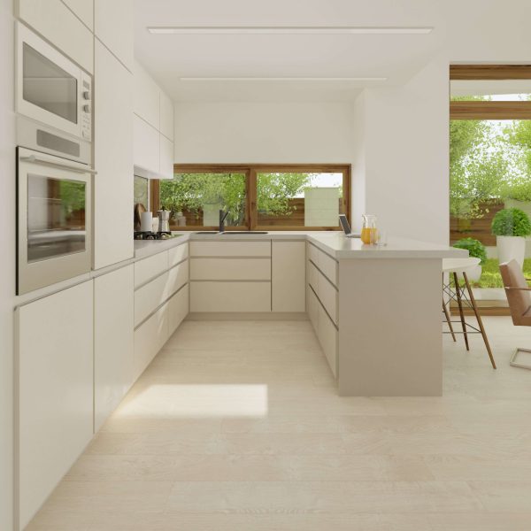 A modern, minimalist kitchen with white cabinets, built-in stainless steel appliances, TORLYS flooring in light wood tones, and an island with bar stools. Large windows showcase greenery outside as sunlight fills the bright, open space.