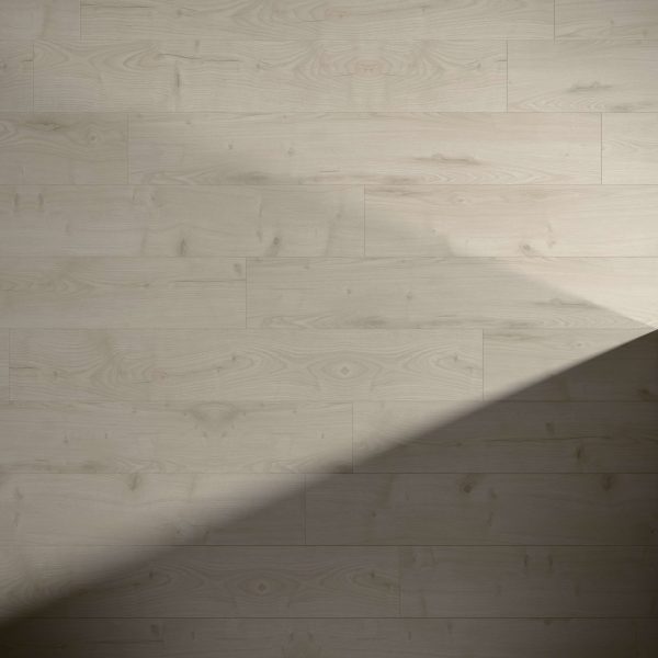 Hawthorne Oak light-colored wooden floor with a natural grain pattern, partly covered by a diagonal shadow cast across the lower right corner.