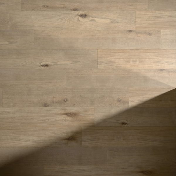 Bowery Oak features a light wooden floor with visible grain patterns and knots, softly illuminated by natural light. A diagonal shadow partially covers the planks in the lower right corner.