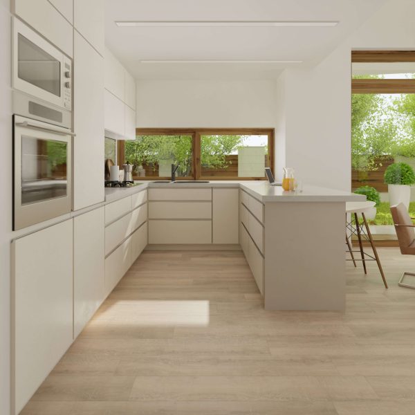 Modern kitchen featuring Beverley Oak flooring, white cabinets, built-in oven and microwave, large windows overlooking green trees, and a central island with stools. Natural light fills the space.