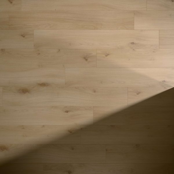 Melrose Oak features a light wooden floor with visible grain patterns and knots. A triangular shadow covers the lower right corner, contrasting the illuminated and shaded areas of the surface.