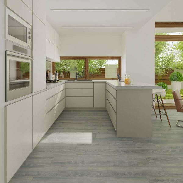 Modern kitchen with white cabinets, built-in appliances, and a spacious island. Large windows overlook a green garden. Ventura Oak floors enhance the clean, minimalist design with their light wood finish.