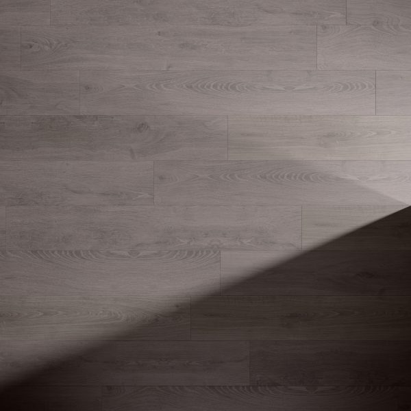 Artesia Oak light brown wooden floor with visible grain patterns, partially covered by a diagonal shadow extending from the bottom right corner toward the center of the image.