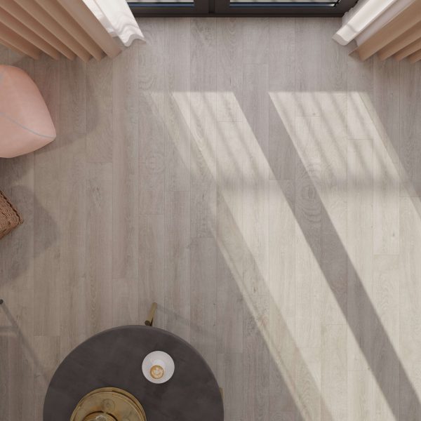 A top-down view of a Venice Oak Grey** floor with sunlight streaming through tall windows, casting diagonal shadows. A round dark table with a candle and a blush pink chair are partially visible in the corners.