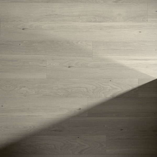 Orion Oak features light wood flooring with a subtle natural grain. A diagonal shadow falls across the bottom right, partially covering the planks for a minimal, softly lit look.