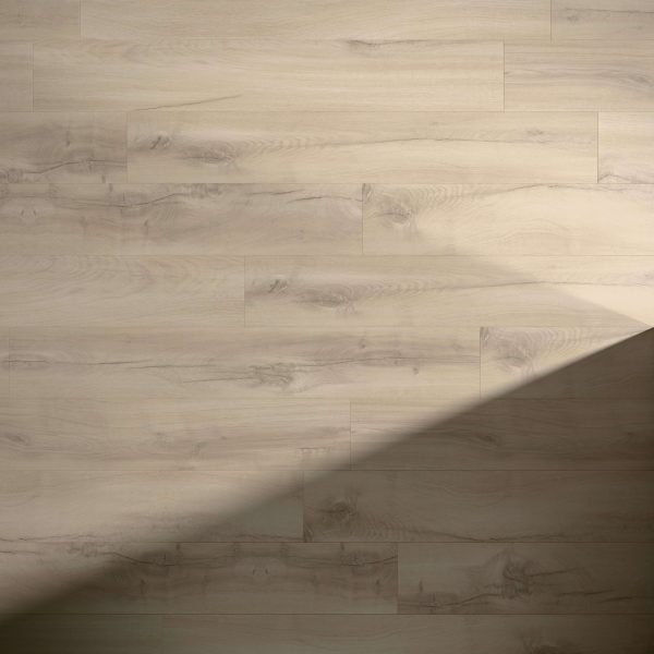 Charleroi Oak floorboards feature a light wood tone and natural grain. A diagonal shadow crosses the lower right, highlighting the contrast with the sunlit upper left area.
