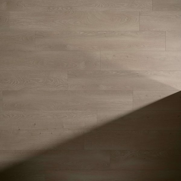 Brussels Oak flooring in light brown with a diagonal shadow stretching from the bottom right, showcasing the wood grain and subtle floorboard texture.