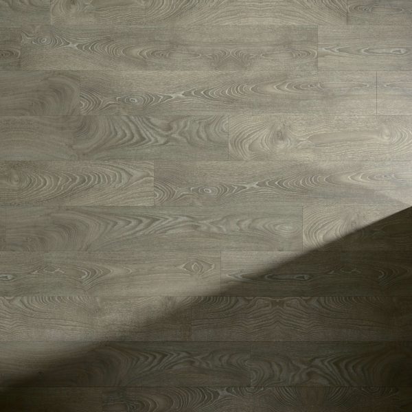 Landen Oak light brown wooden floor featuring a natural grain pattern, partially covered by a shadow stretching diagonally from the bottom right corner.