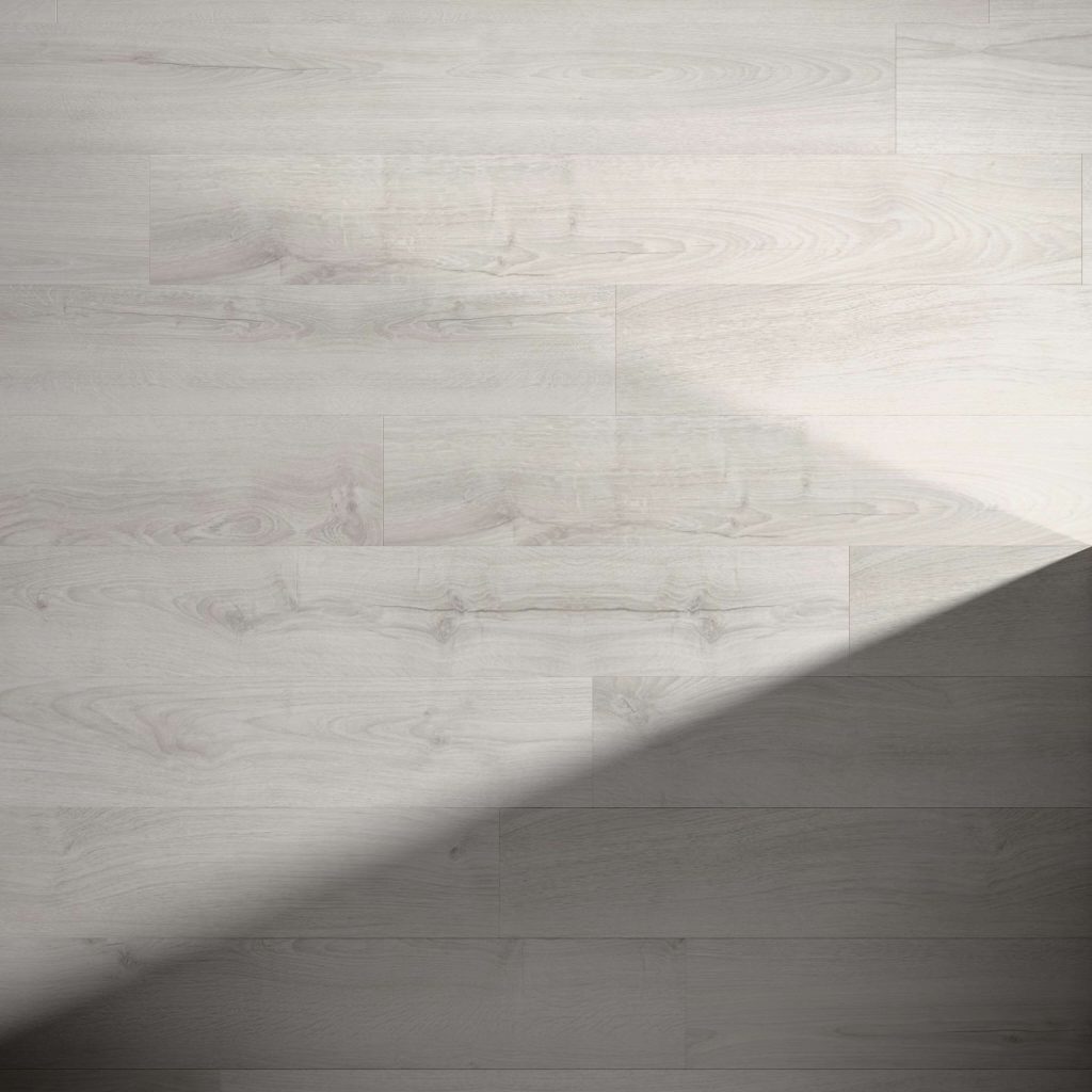 The Elkington features a light gray wooden floor with visible grain and subtle knots, its surface partially shaded in the lower right corner for a striking contrast between illuminated and shadowed areas.