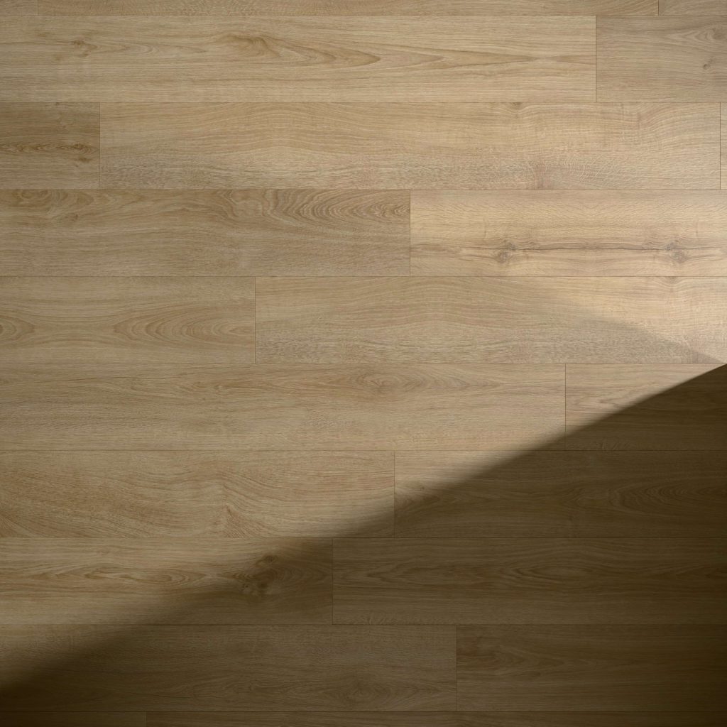 Brightstone light brown wooden floorboards feature natural grain patterns. A diagonal shadow extends from lower left to upper right, enhancing the contrast between the illuminated and shaded sections.