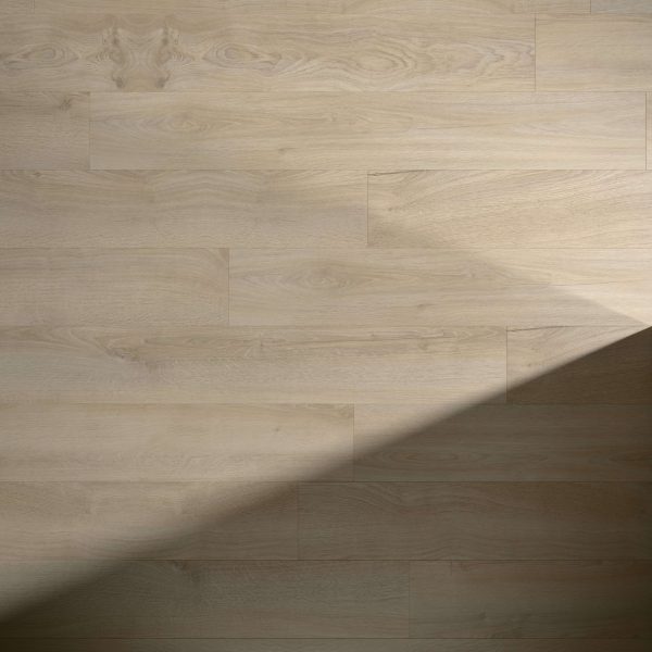 Sandilands* light wood floor showcases a natural grain pattern in a staggered plank layout. A diagonal shadow on the right side highlights the contrast between illuminated and shaded areas.