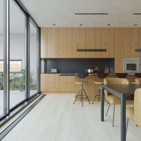 Modern kitchen featuring Rondeau* floor-to-ceiling windows, wooden cabinets, black backsplash, built-in appliances, and a dining area with tan chairs. Potted plants are visible outside through the large glass windows.