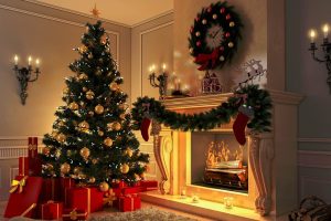 A decorated Christmas tree with gold ornaments and lights stands beside a fireplace adorned with stockings, a wreath, garland, and candles—classic Holiday Decorating Ideas. Wrapped presents sit under the tree.