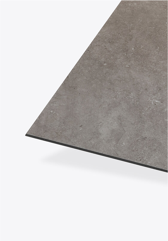 A close-up view of a thin, rectangular gray slab or tile with a smooth, stone-like texture, shown against a plain white background.